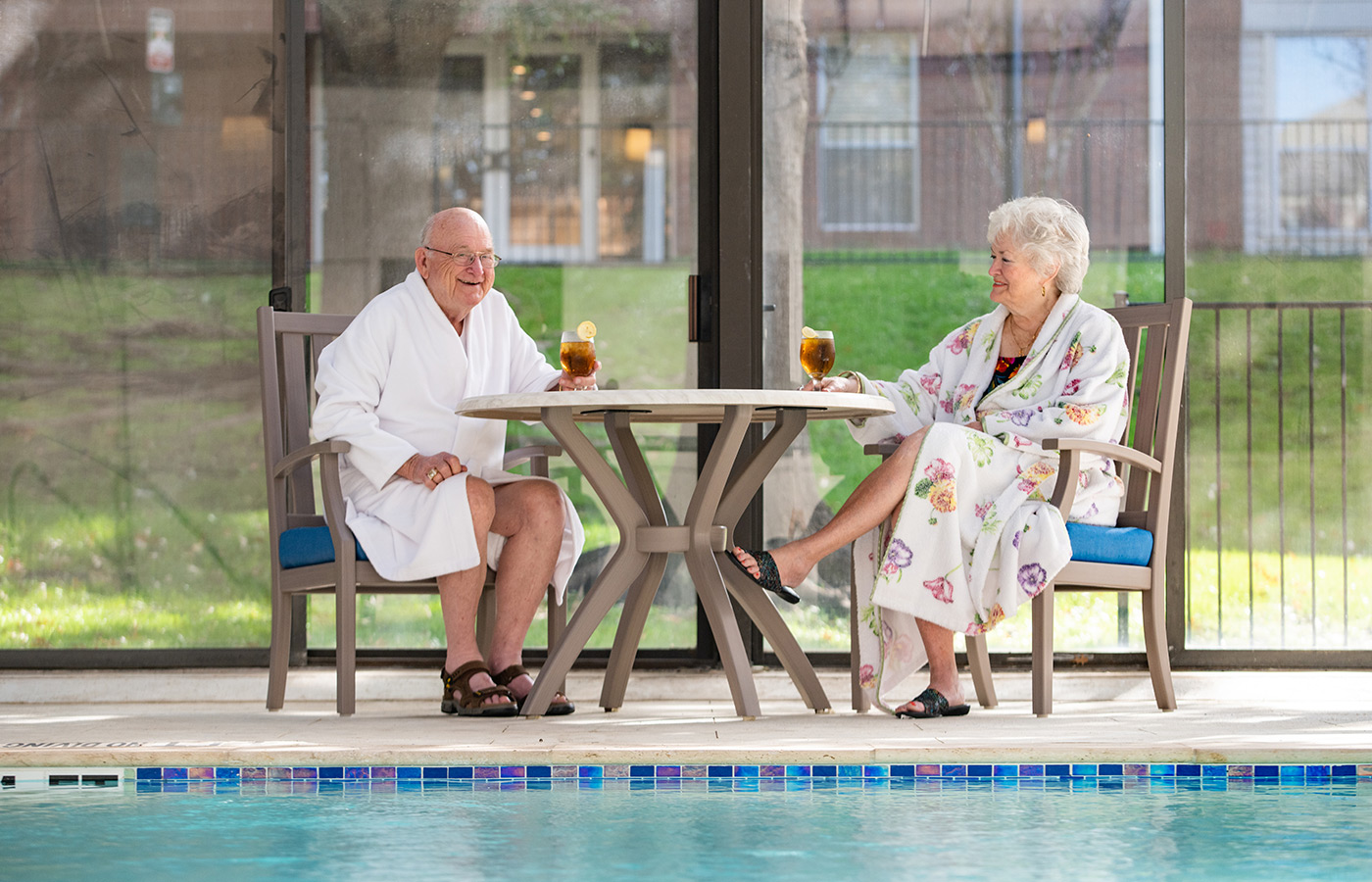 Couple relaxing by the pool at Broadway Cityview